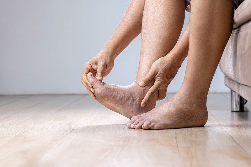Senior Man massage foot with painful swollen gout inflammation